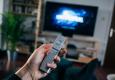 Smart TV with Remote Control and Universal Logo on the Screen © unsplash.com/Jonas Leupe